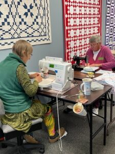 Volunteers making quilts with sewing machines